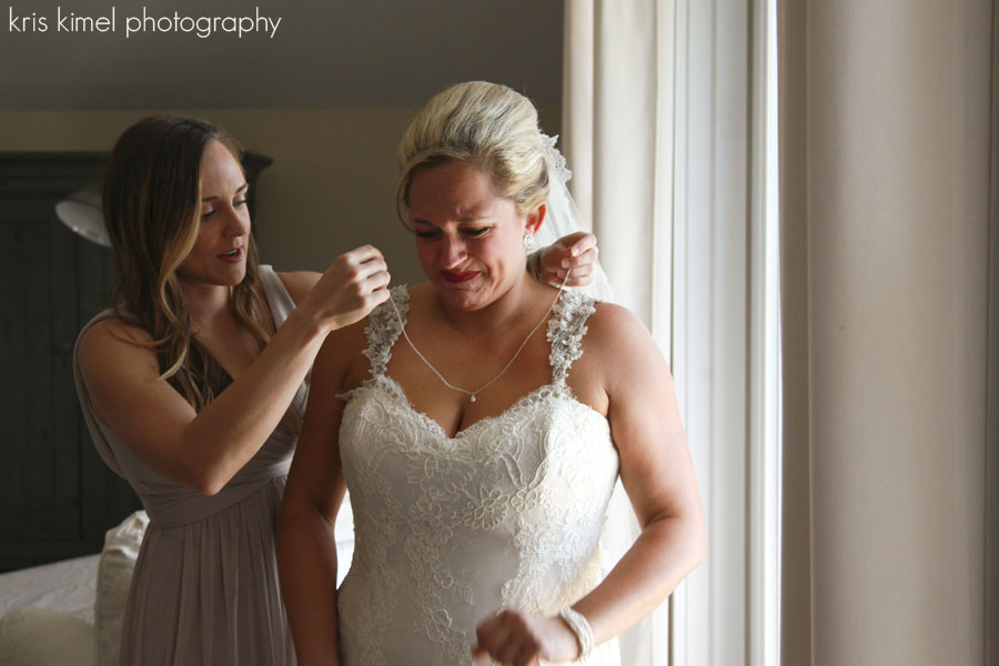 emotional moment of bride with sister and mother