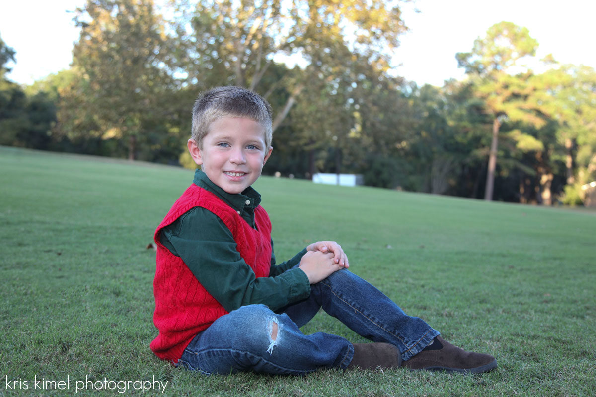 Holiday portrait of a smiling little boy at Killearn Country Club in Tallahassee, Florida