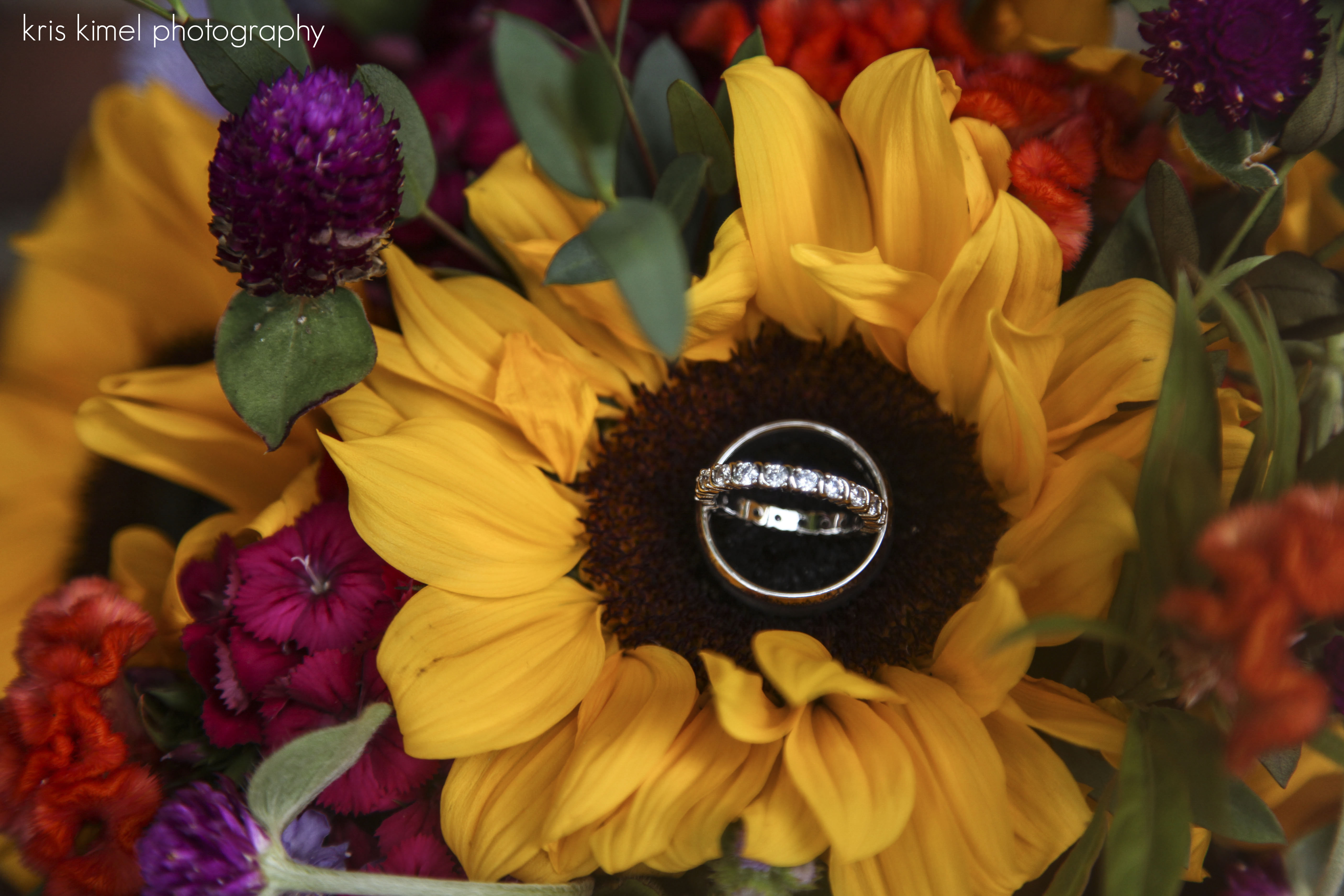 photo of sunflower wedding bouquet and wedding rings