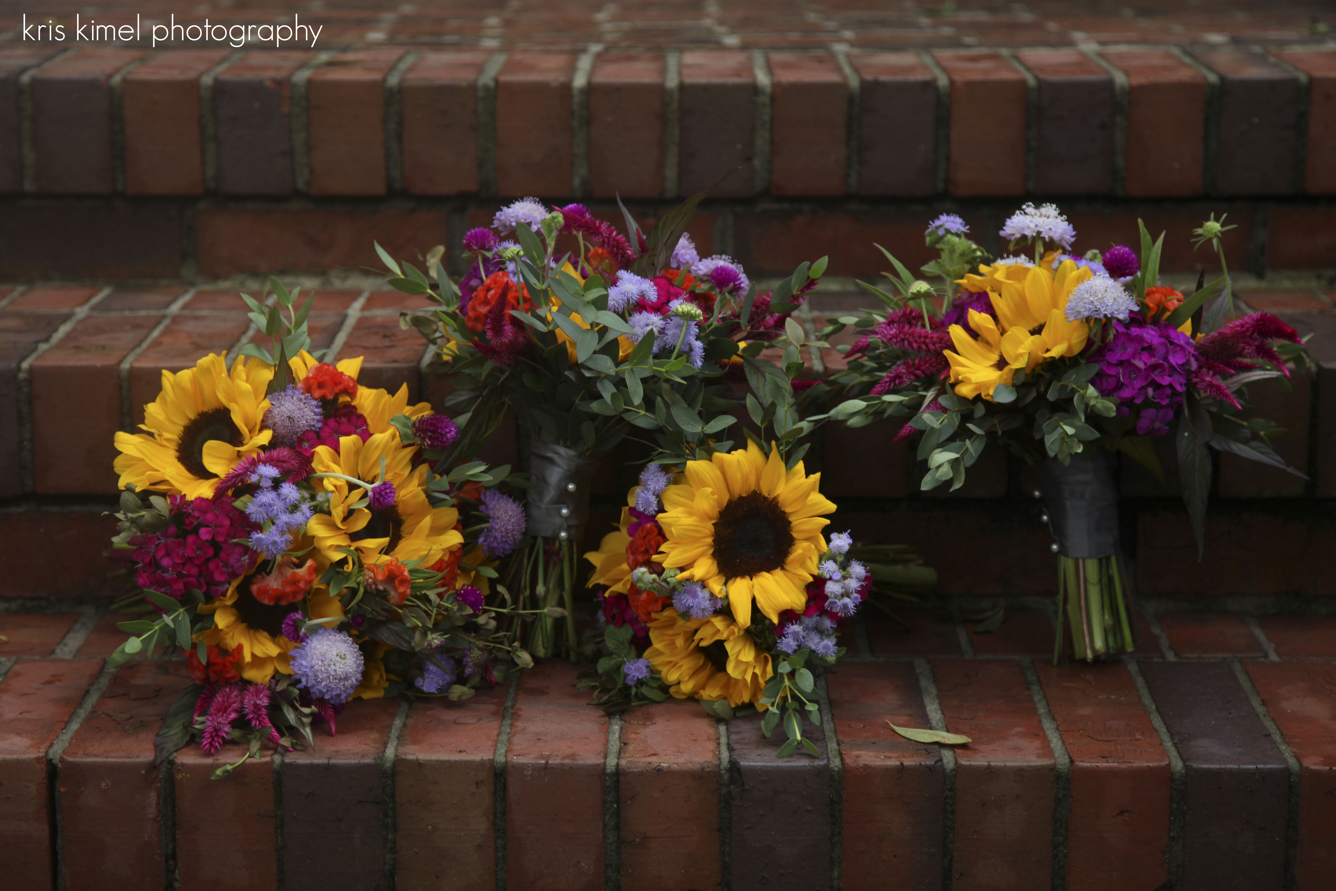 photo of colorful wedding bouquets featuring sunflowers