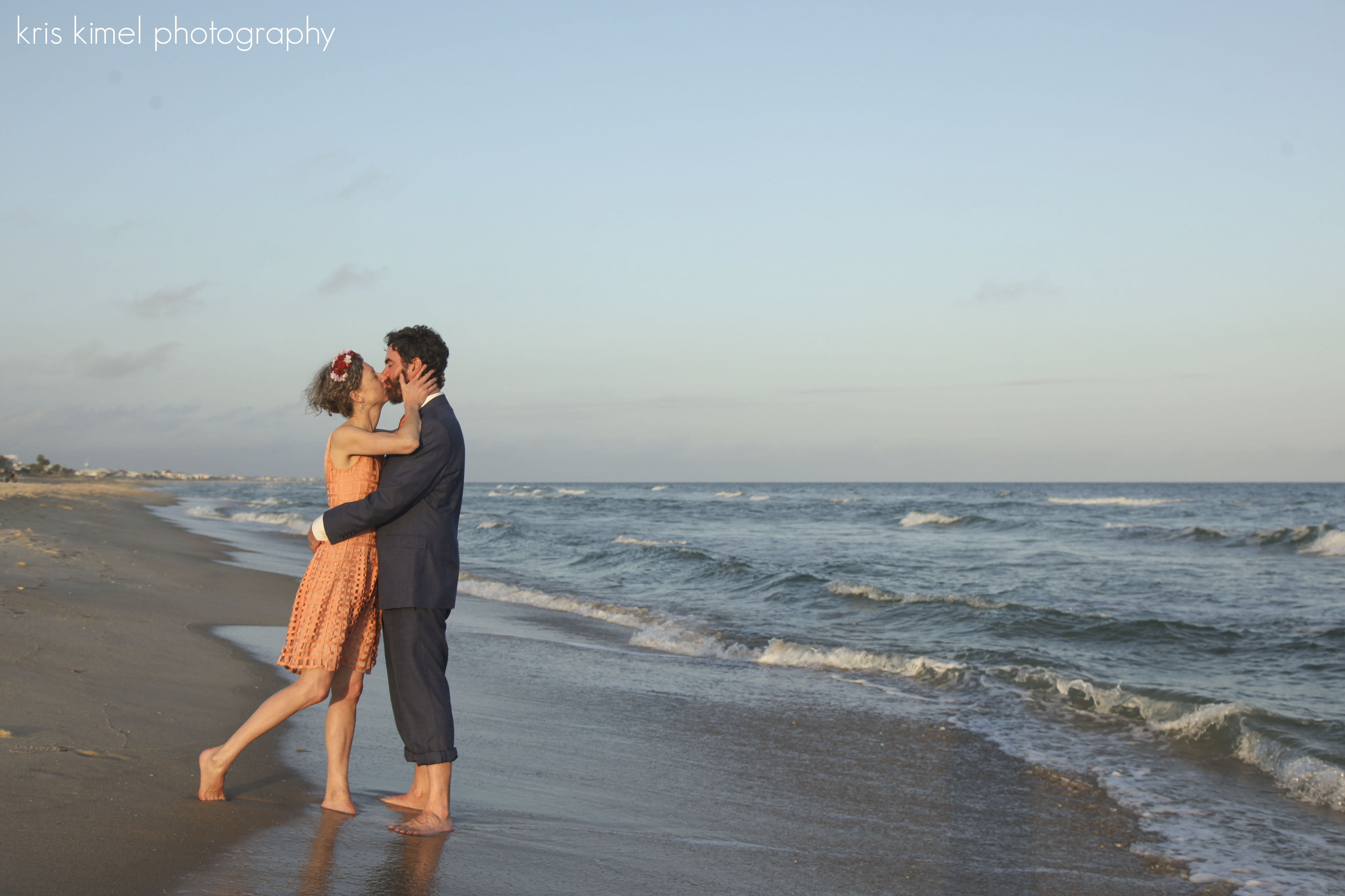 Portrait of bride and groom kissing on St. George Island beach