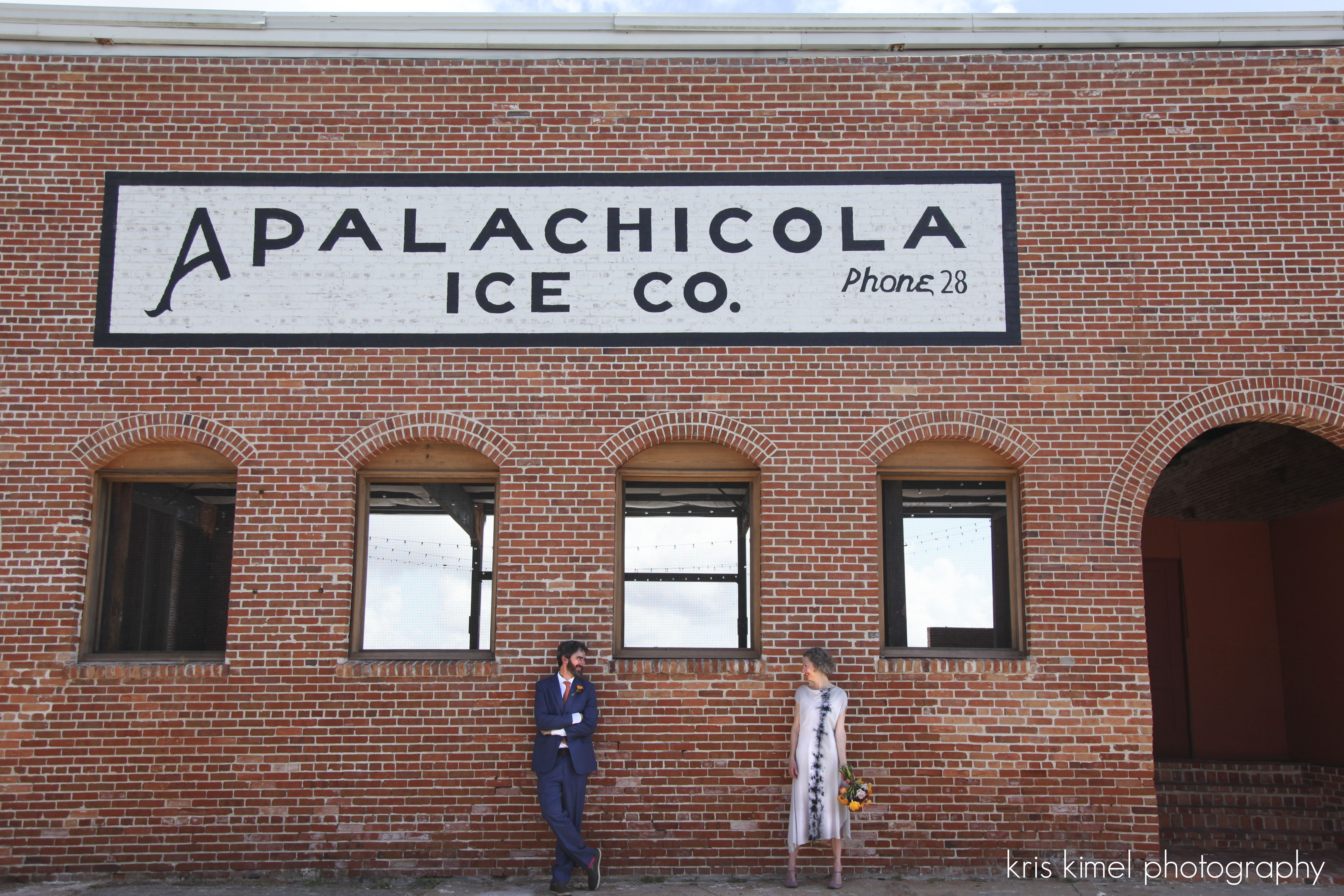 Portrait of bride and groom in front of the Apalachicola Ice House
