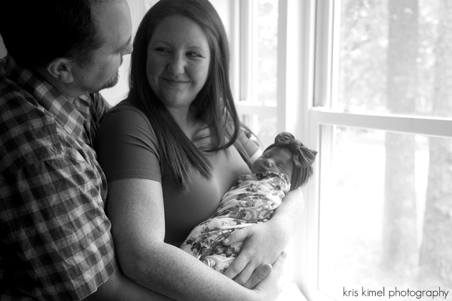 black and white portrait of parents with newborn baby